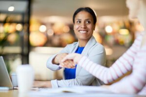 A GoReminders user shaking hands with their happy customer