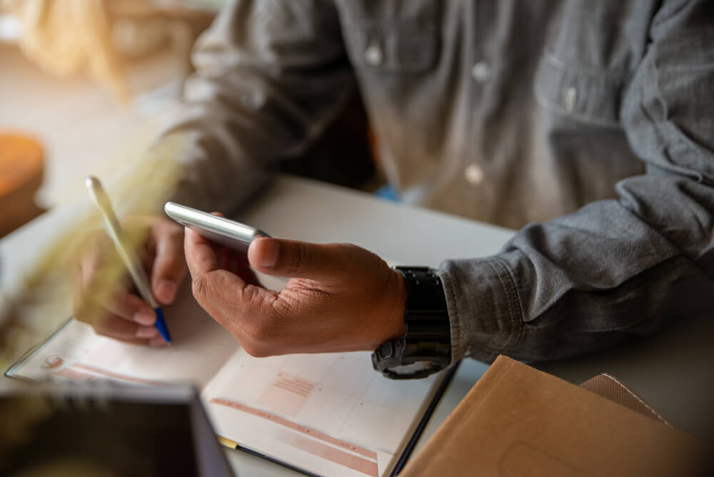 Man checking phone to see an appointment reminder