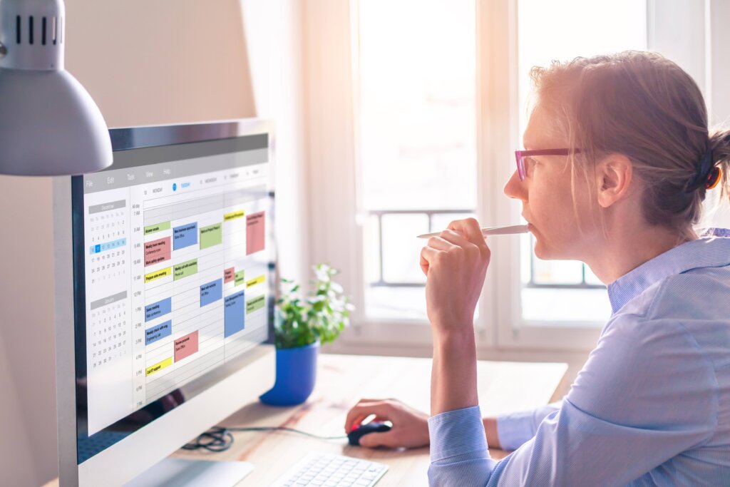 Person using calendar on computer to improve time management