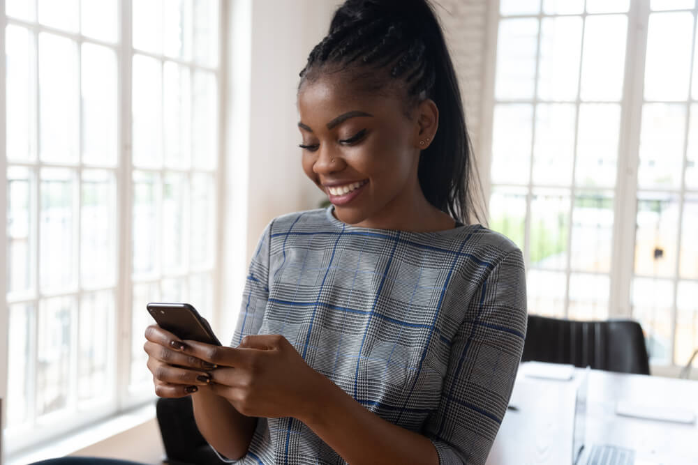 Close Up Attractive African Businesswoman Using Smartphone Standing Inside Of